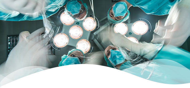 Low angle view of team of doctors working in blurred motion at operating room.